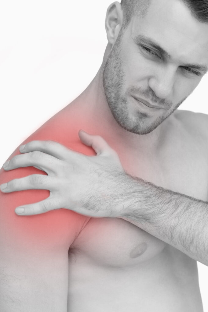 closeup shirtless man with shoulder pain white background